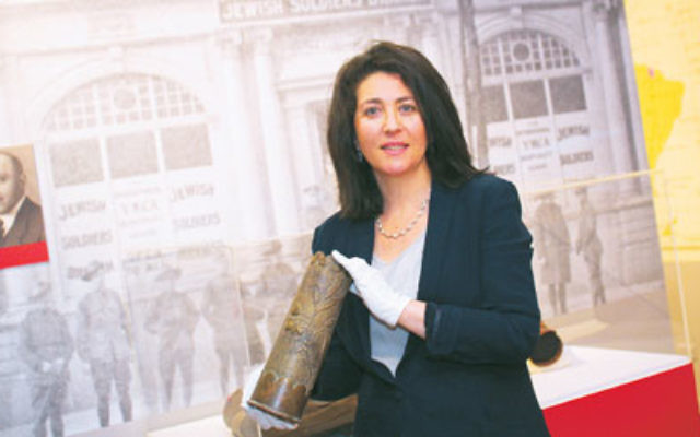 Curator Deborah Rechter holds a shell casing that was transformed into trench art during World War I. Photo: Peter Haskin
