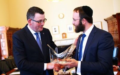 Premier Daniel Andrews (left) is presented with a shofar from RCV vice president Rabbi Daniel Rabin. Photo: Peter Haskin
