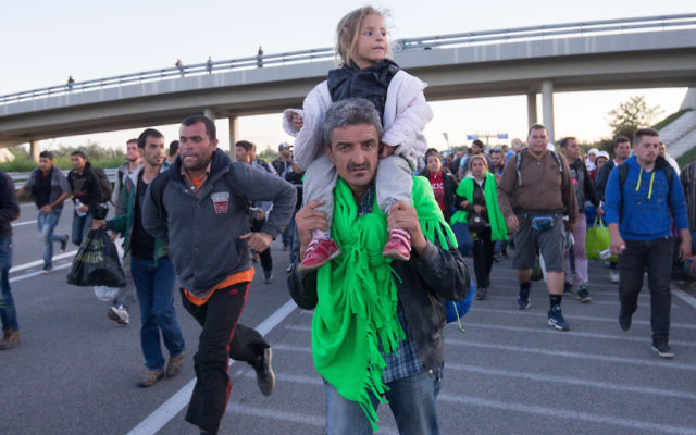 Refugees walking along a motorway near the southern Hungarian village of Roszke last week.
Photo: Matt Cardy/Getty Images