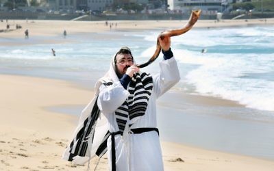 Rabbi Eli Schlanger blowing the shofar at Bondi Beach. Photo: Noel Kessel