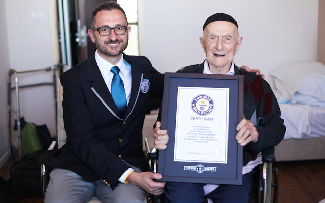 Marco Frigatti, head of records for Guinness World Records, presents Israel Kristal his certificate of achievement for Oldest living man, in Haifa, Israel, March 11, 2016.