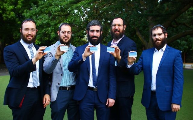 From left: Rabbi Daniel Rabin, Rabbi Chaim Cowen, Rabbi Yaakov Glasman, Rabbi Menachem Wolf and Rabbi Velly Slavin showing off their HODS cards. Photo: Peter Haskin.