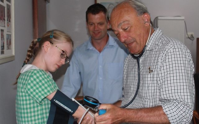 Labor candidate for Macarthur, Dr Mike Freelander, treating a young patient.