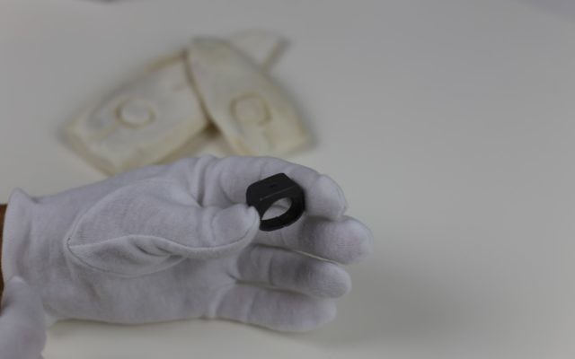 The lead model used to make Oskar Schindler's ring, with ring moulds in the background. Photo: Jewish Holocaust Centre