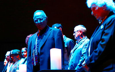 Among those lighting candles in memory of the six million victims of the Holocaust were Fred Antman and Maria Curtis. Photo: Peter Haskin.