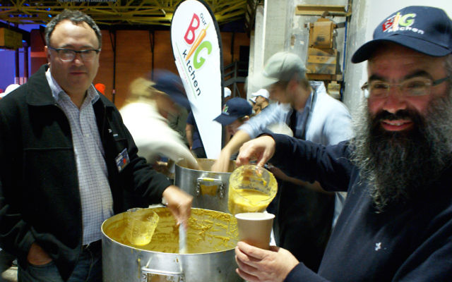 Our Big Kitchen’s general manager Russel Levert and executive director Rabbi Dovid Slavin serving soup at Carriageworks in Sydney on June 23 for the Vinnies CEO Sleepout. Photo: Shane Desiatnik.