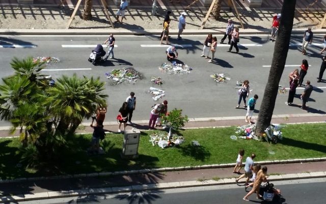 Gary and Sheila Esterman’s view of the Nice boulevard where 84 people were killed by a terrorist last week. Flowers have been left by family and friends of those killed.