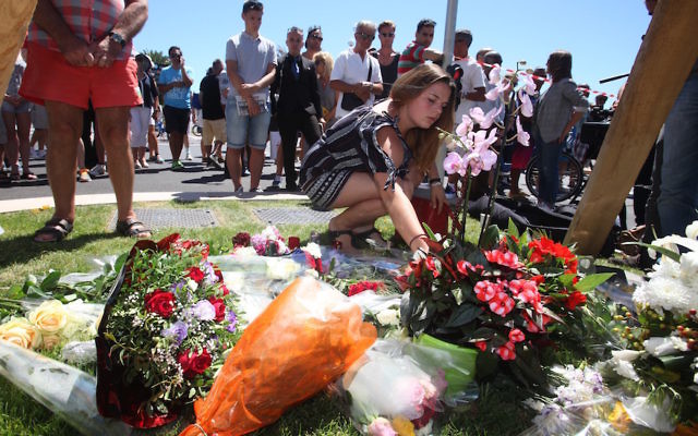 NICE, FRANCE - JULY 15: People visit the scene and lay tributes to the victims of a terror attack on the Promenade des Anglais on July 15, 2016 in Nice, France.