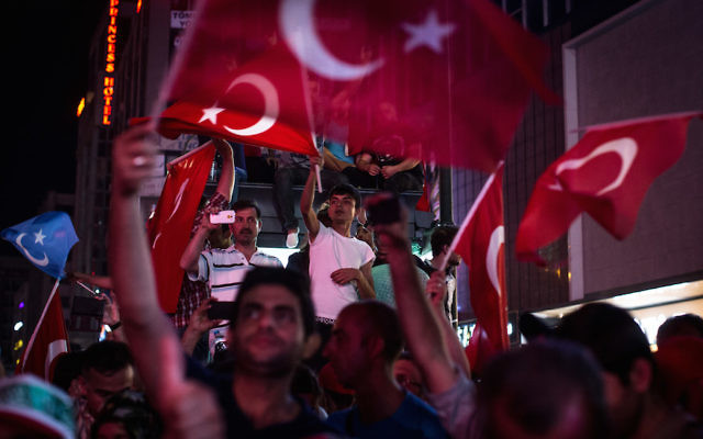 Turks waving their nation’s flag at a rally in Ankara’s Kizilay Square in reaction to the failed military coup, July 17, 2016.