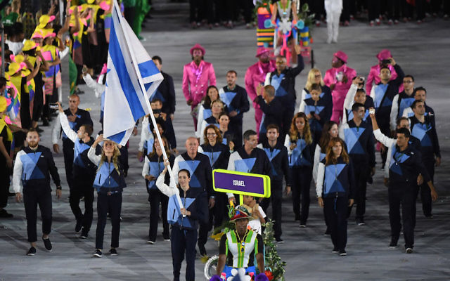 Israel's flagbearer Neta Rivkin leads her delegation during the opening ceremony of the Rio 2016 Olympic Games. (PEDRO UGARTE/AFP/Getty Images)