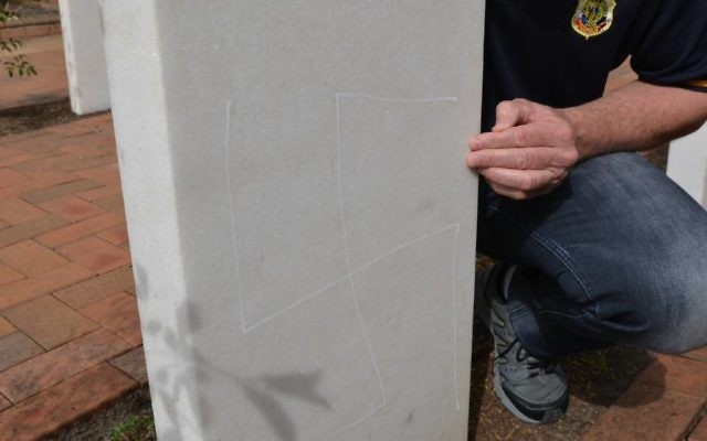 One of the swastikas drawn on the back of a headstone. Photo: South Coast Register
