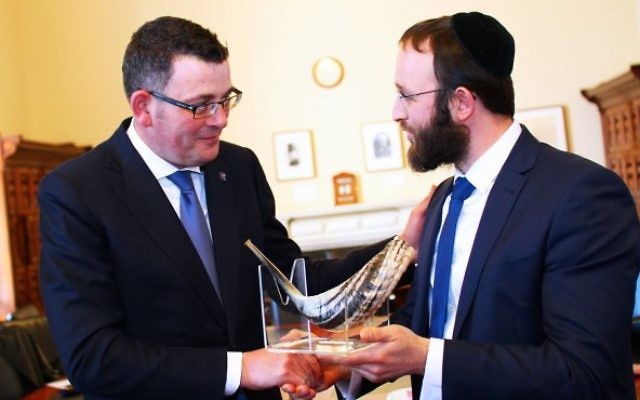 Premier Daniel Andrews (left) is presented with a shofar from Rabbi Rabin.
