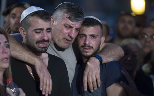he father and brother of Israeli policeman 1st Sgt. Yosef Kirme mourning at the funeral on Mt. Herzl Military Cemetery in Jerusalem for burial 09 October 2016. Kirma was killed earlier today in a shoot out with a Palestinian from the Jerusalem area who opened fire at passenger cars in East Jerusalem, killing two people before he was killed. The Palestinian attacker, according to police, was due to start serving a jail term today for assaulting an Israeli police officer.  EPA/JIM HOLLANDER