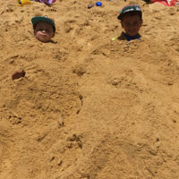 Rachel Teller entered this photo of her children Raph and  Noah buried in the sand at the beach in Sydney.