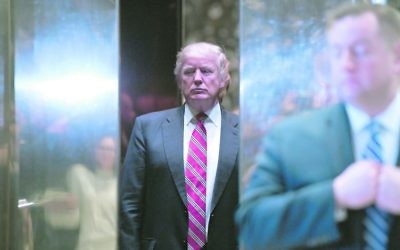 US President-elect Donald Trump stands inside the lobby elevator of Trump Tower. Photo: EPA/Anthony Behar/SIPA USA POOL.