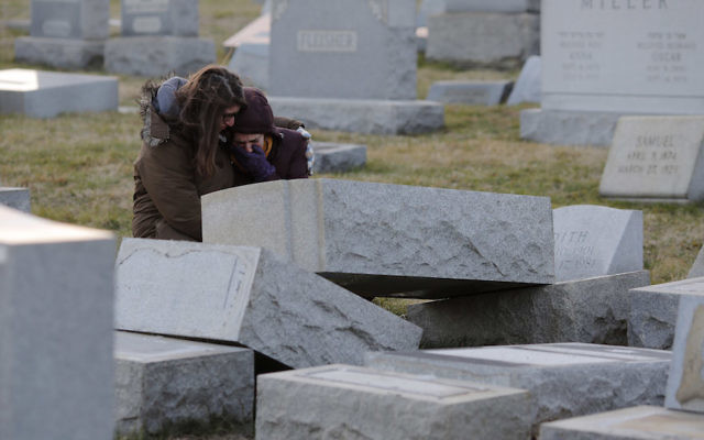 Melanie Steinhardt comforting Becca Richman at the Jewish Mount Carmel Cemetery in Philadelphia. Photo: Dominick Reuter/AFP/Getty Images