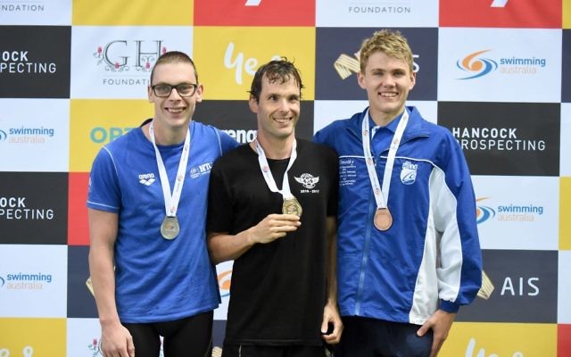 Matthew Levy (centre) with his 2017 Australian Swimming Championships gold medal for the men’s multiclass 200m individual medley, alongside silver medallist (left) Timothy Disken and bronze medallist (right) Timothy Hodge. Photo: Delly Carr/Swimming Australia Ltd