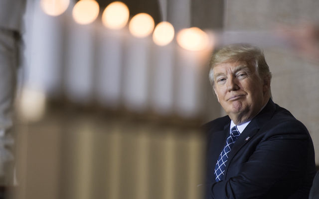 President Donald Trump watches the lighting of memorial candles during the annual Days of Remembrance Holocaust ceremony in the Capitol Rotunda on April 25, 2017. (Photo By Tom Williams/CQ Roll Call)
