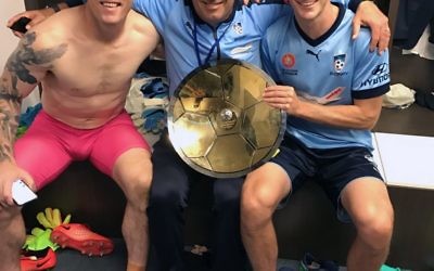 Michael Swibel (centre) flanked by Grand Final heroes Danny Vukovic and Male Wilkinson holding the Premiers' Plate.