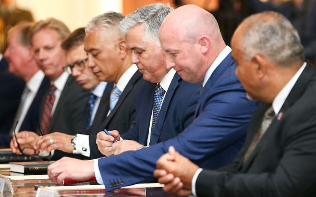 New Zealand’s new government ministers, including Alfred Ngaro (fourth from right), Mark Mitchell (third from right) and David Bennett (second from right) at Government House in Wellington. (Hagen Hopkins/Getty Images)