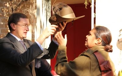 Julian Leeser presenting a replica slouch hat to Elsie Amamoo. 
Photo: Shane Desiatnik