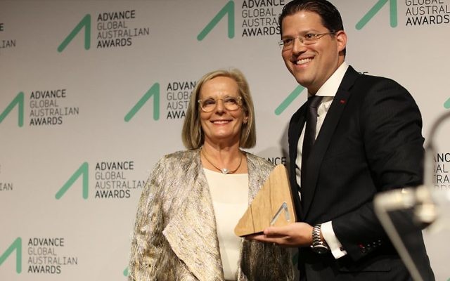 Jeremy Balkin (right) receives his award from Lucy Turnbull.
