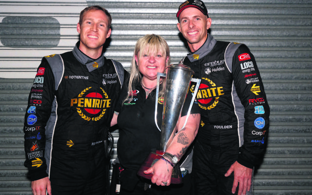 Betty Klimenko, who owns Erebus Motorsport, holding the Peter Brock Trophy with her drivers David Reynolds (left) and Luke Youlden at the Bathurst 1000.
