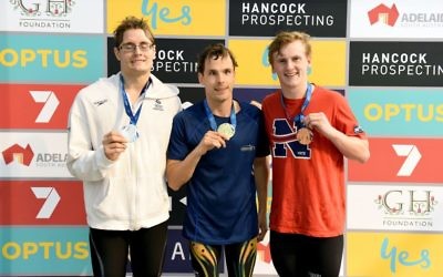 Matthew Levy (centre) wearing one of two gold medals he won at the 2017 Australian Short Course Championships in Adelaide last week. Photo: Delly Carr / Swimming Australia