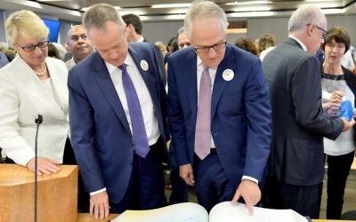 Counsel Assisting Gail Furness, Federal Opposition Leader Bill Shorten and Prime Minister Malcolm Turnbull look through the Message to Australia book containing hand-written letters from victims of child sexual abuse at the final sitting of the Royal Commission.
Photo: AAP Image/ Supplied by the Royal Commission 
into Institutional Responses to Child Sexual Abuse