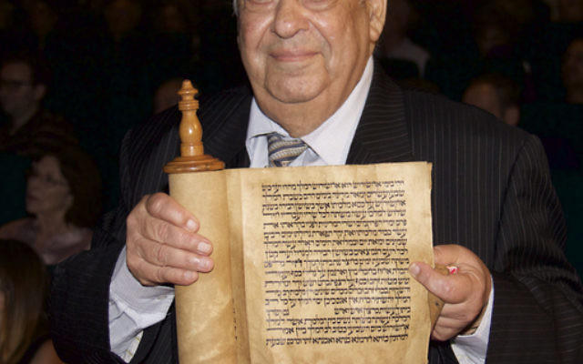 Iraqi-born Alfred Gubbay, president of the Sephardi Federation of Australian Jewry, holding a Megillah scroll from Baghdad. Photo: Wendy Lessick Bookatz