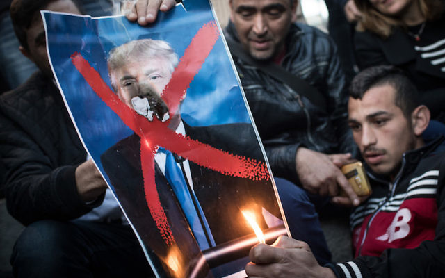 Protesters burn a poster of Donald Trump in front of the Damascus Gate on Monday. Photo: Chris McGrath/Getty Images