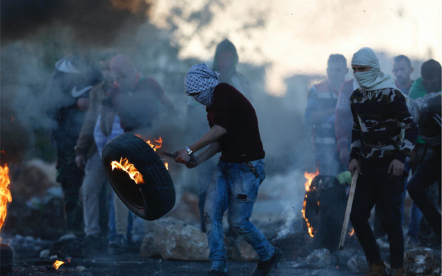 Palestinian protesters following the death of Ibrahim Abu Thurayya. Photo: AP Photo/Majdi Mohammed