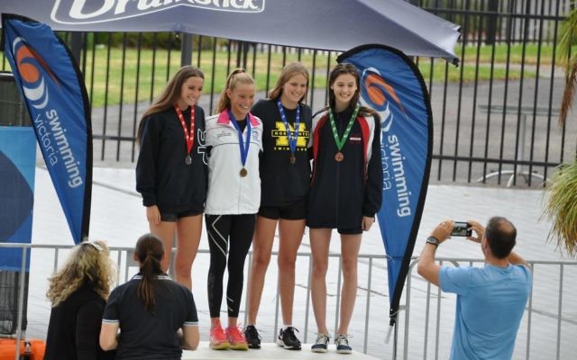 Ashley Weill (second from right) on the podium.