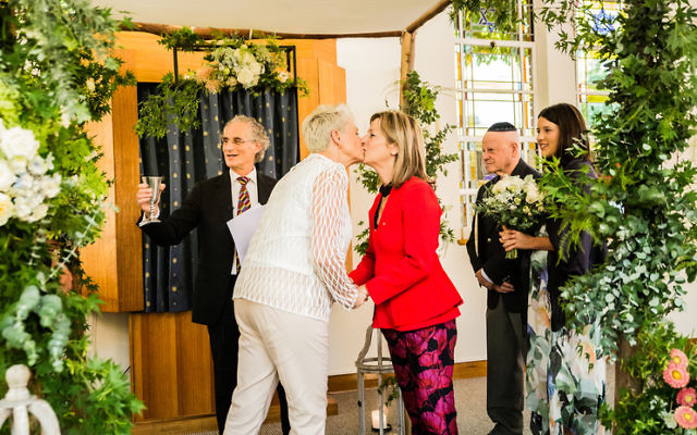 L'chaim! Dr Kerryn Phelps (left) kissing her wife Jackie Stricker-Phelps after the ceremony at Emanuel Synagogue last week. Photo: Same Love Photography