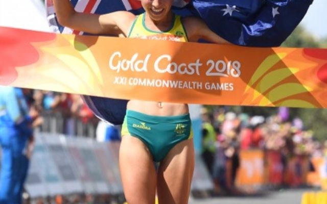 Jemima Montag crosses the finish line to win the Women's 20km Race Walk final on day four of competition at the XXI Commonwealth Games at Currumbin Beachfront on the Gold Coast, Australia, Sunday, April 8, 2018. (AAP Image/Tracey Nearmy) NO ARCHIVING, EDITORIAL USE ONLY