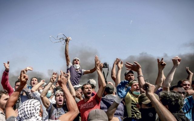 Palestinian protesters near the Gaza border on Monday. Photo: EPA/Mohammed Saber