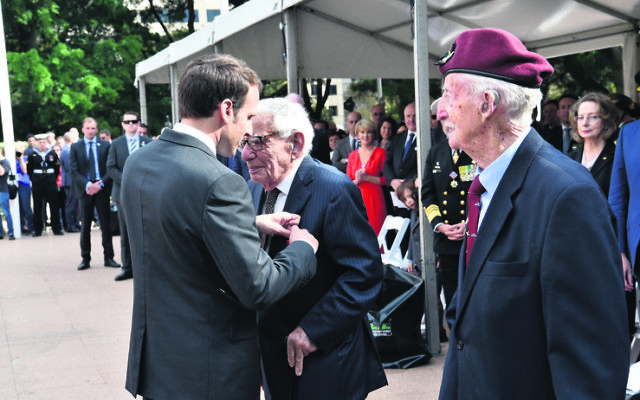French President Emmanuel Macron presenting Lou Solomons with the Legion of Honour.
