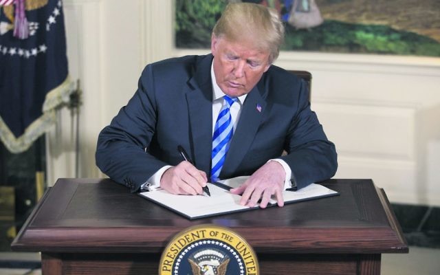 Donald Trump signing a national security presidential memorandum on Iran on Tuesday. Photo: EPA/Michael Reynolds