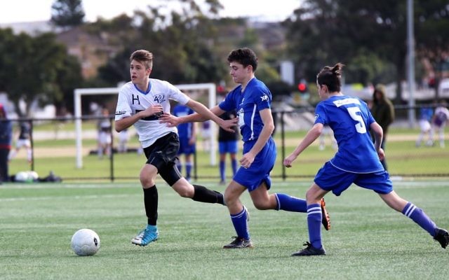 U15s action between NCMJFC (white) and MHJFC at the inaugural interstate Challenge Cup in Sydney on June 11. Photo: Noel Kessel