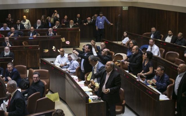 Arab lawmakers protest as the Knesset debates the nation-state bill.  Photo: AP Photo/Olivier Fitoussi