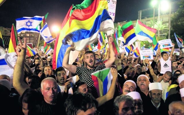 Thousands joined the Druze protest against the new law on Saturday night in Tel Aviv. Photo: AP Photo/Sebastian Scheiner