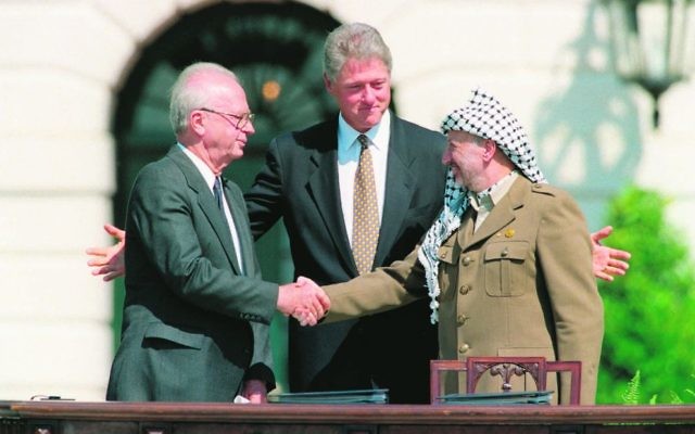 President Bill Clinton (centre), presiding over ceremonies marking the signing of the 1993 peace accord between Israeli Prime Minister Yitzhak Rabin (left) and PLO chairman Yasser Arafat on September 13, 1993. Photo: AP Photo/Ron Edmonds