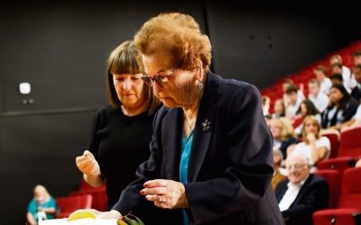 Survivor Edith Gluck lights a memorial candle with her daughter Donna at 
 Secondary College's Holocaust Remembrance Service. Photo: Peter Haskin