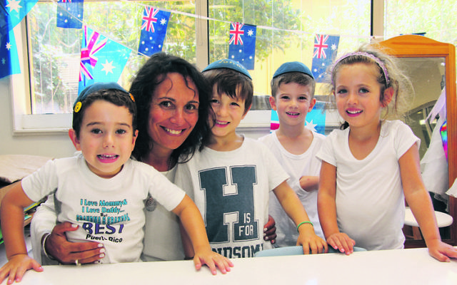 Moriah Early Learning Centre teacher Ilana Joseph with students Danny, Jonah, Jake and Gia at one of Moriah's 75th anniversary functions.
Photo: Shane Desiatnik