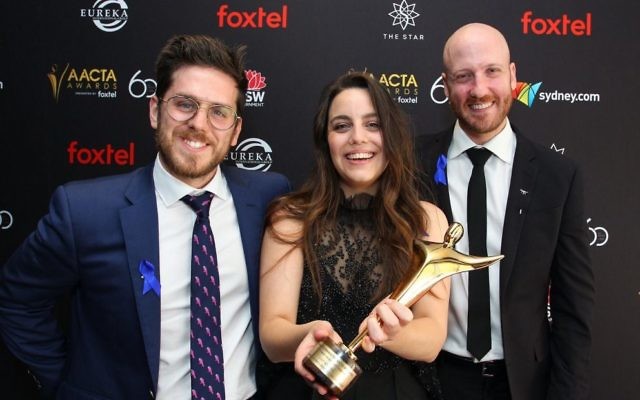 From left: co-director Andrew Goldsmith, producer Lucy Hayes and co-director Bradley Slabe with their AACTA Award. Photo: AACTA