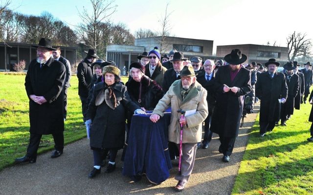 A group of survivors wheel a coffin with the remains of six unknown Jews murdered at Auschwitz, to be buried at the United Synagogue's New Cemetery in Bushey. Photo: John Stillwell/PA Wire