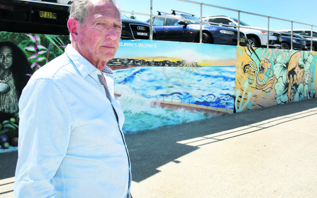 Holocaust survivor Peter Halas at Bondi Beach in front of Anthony Glick's mural – one of many that was defaced in last weekend's antisemitic graffiti attack. Photo: Noel Kessel