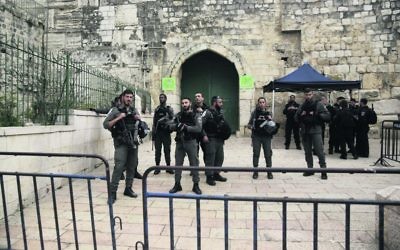 Israeli border police block the entrance to al-Aqsa compound in Jerusalem last Tuesday after Palestinian suspects threw a firebomb at a police station. Photo: AP Photo/Mahmoud Illean