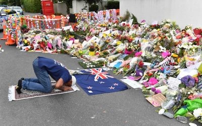 A Muslim worshipper prays at a makeshift memorial near the Al Noor Mosque
in Christchurch. Photo: AAP Image/Mick Tsikas