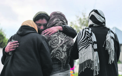 Muslim worshippers grieving at a makeshift memorial at Christchurch’s Al Noor Mosque. Photo: AAP Image/Mick Tsikas